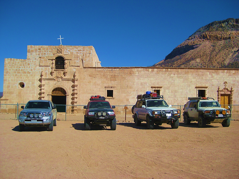A car parked in a parking lot in front of a building
