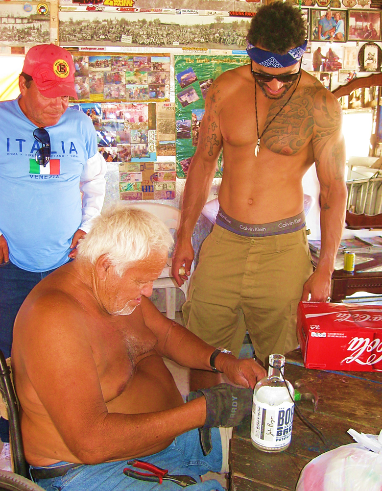 A picture containing person, man, sitting, holding