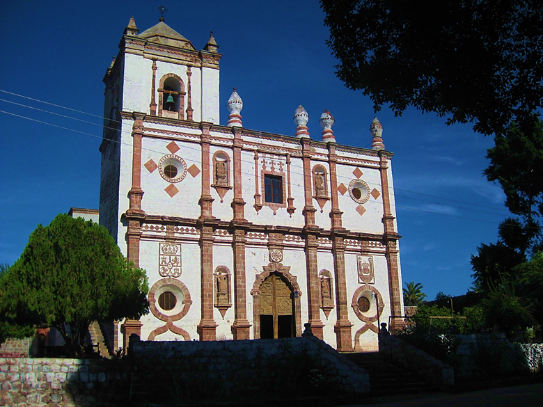 A large stone building with a clock tower Description automatically generated