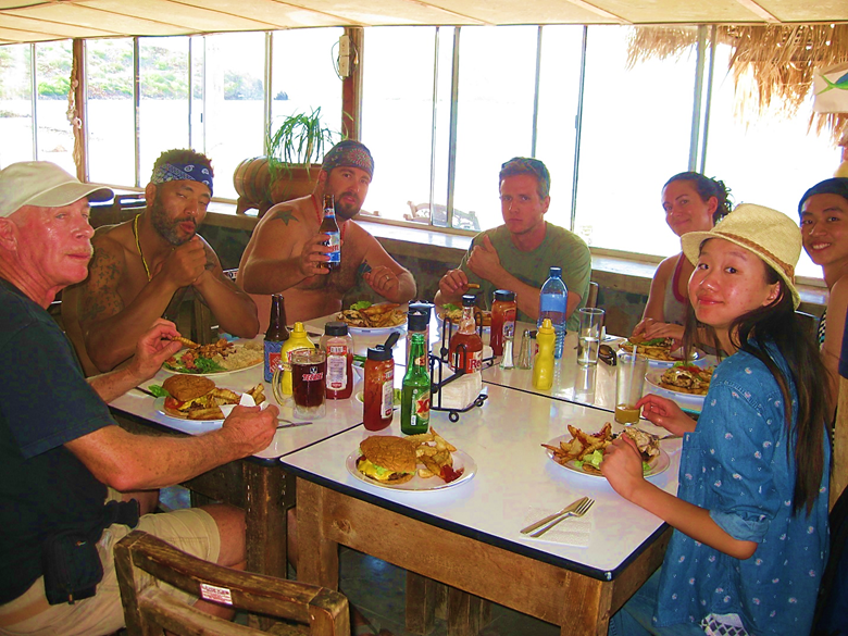 A group of people sitting at a table in a restaurant Description automatically generated