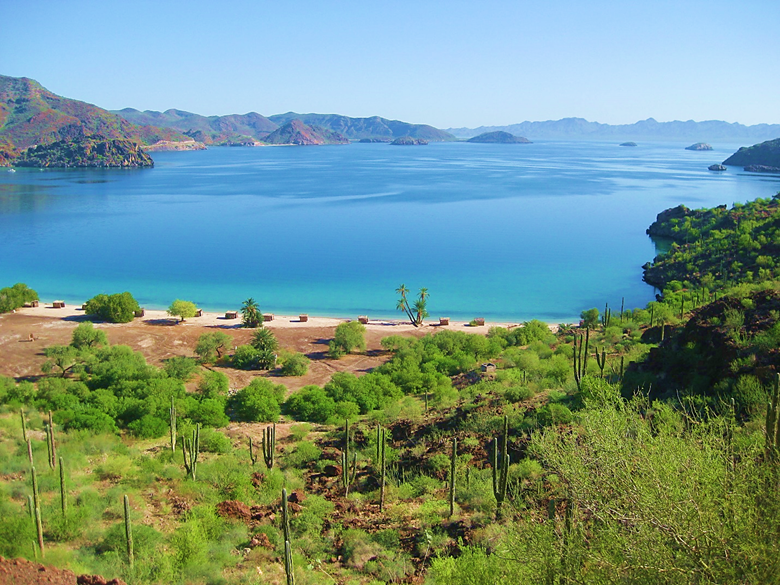 A large body of water with a mountain in the background Description automatically generated
