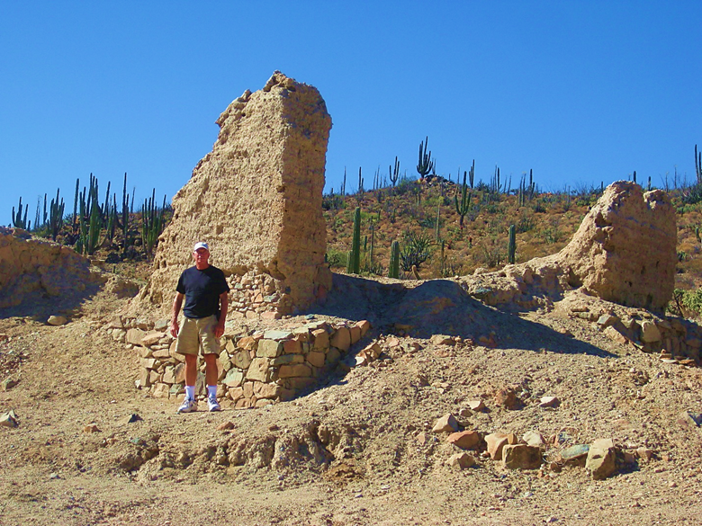 A person standing on a rocky hill Description automatically generated