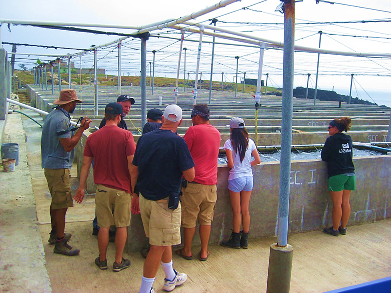 A group of people standing around a track Description automatically generated