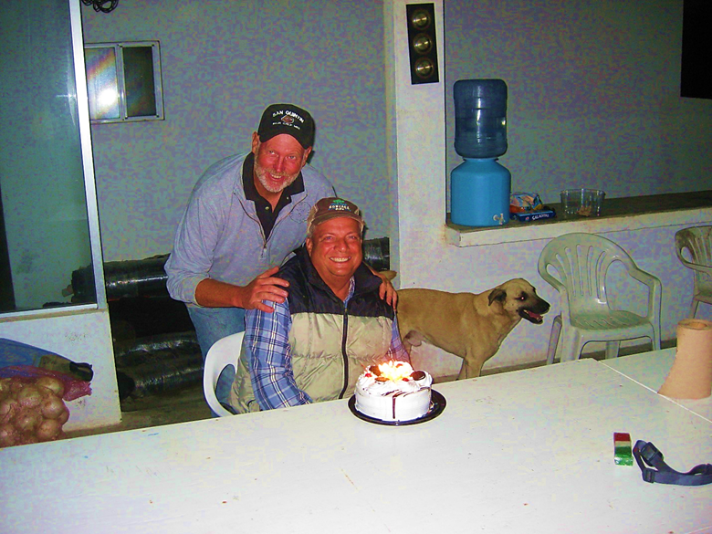 Two people sitting at a table Description automatically generated